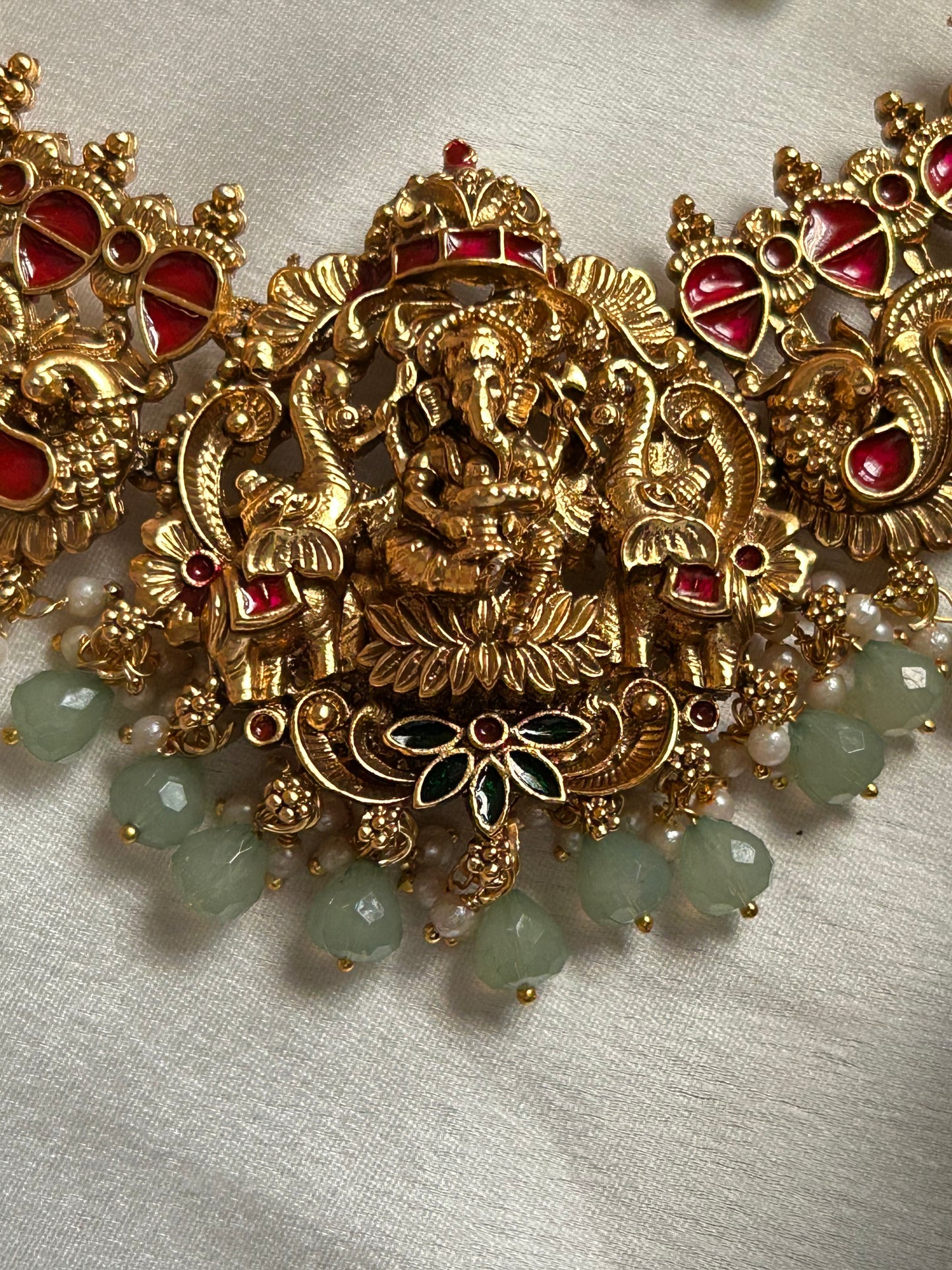 Premium pastel green beaded Nagas Necklace set with lord Ganesh pendant.