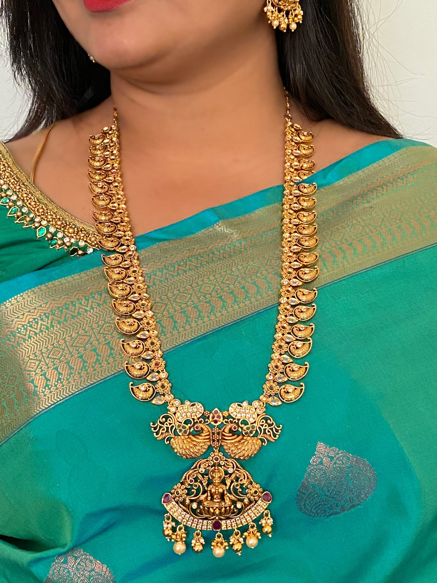 Luxehara's Long Mango haaram with Lakshmi pendant along with earrings.