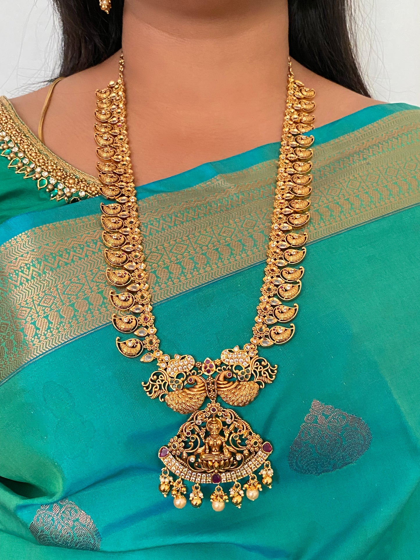 Luxehara's Long Mango haaram with Lakshmi pendant along with earrings.