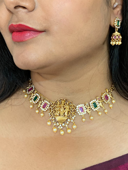 LuxeHara Ram Parivar Choker along with earrings with added red and green stones and hanging pearls.