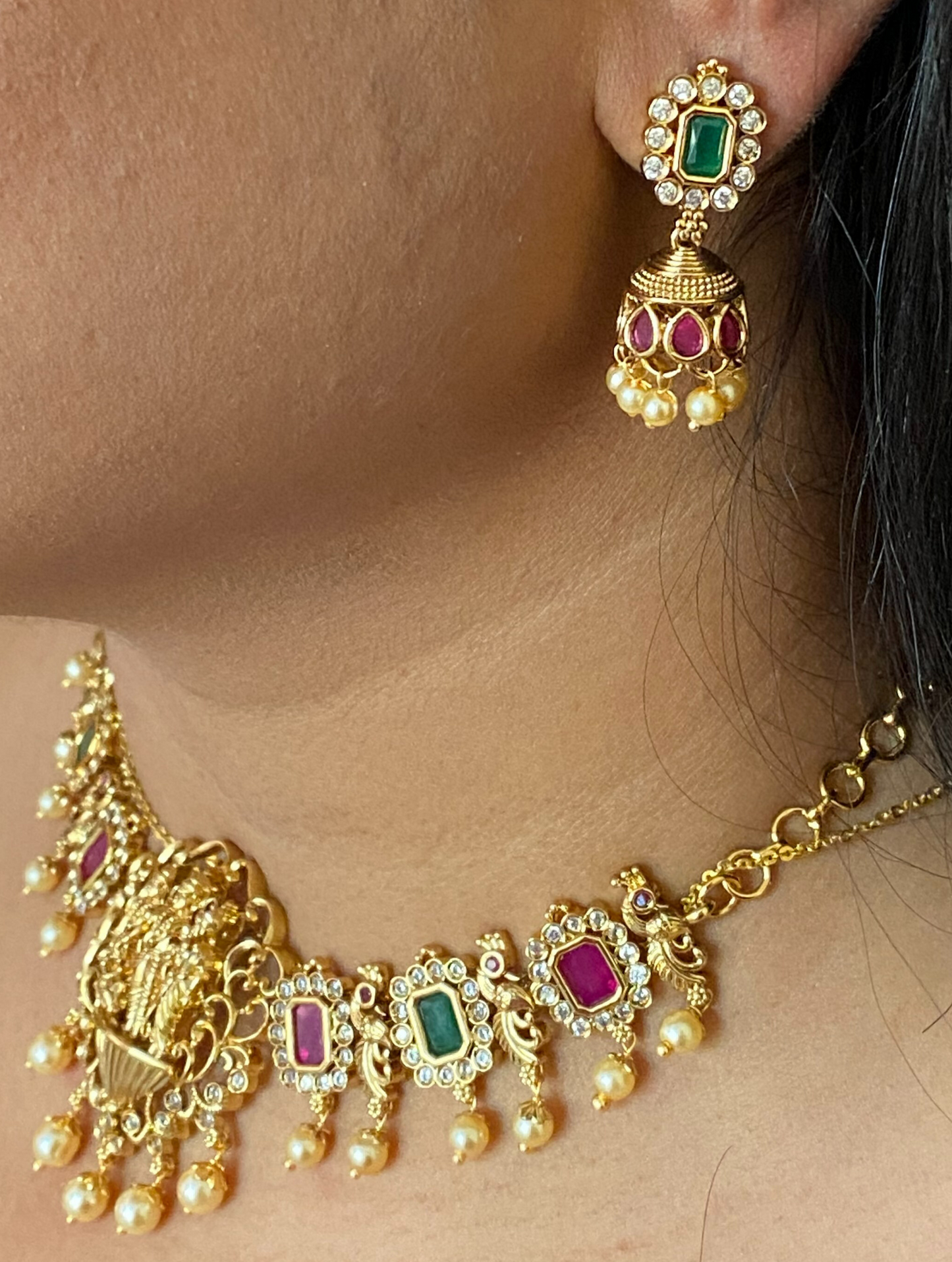 LuxeHara Ram Parivar Choker along with earrings with added red and green stones and hanging pearls.