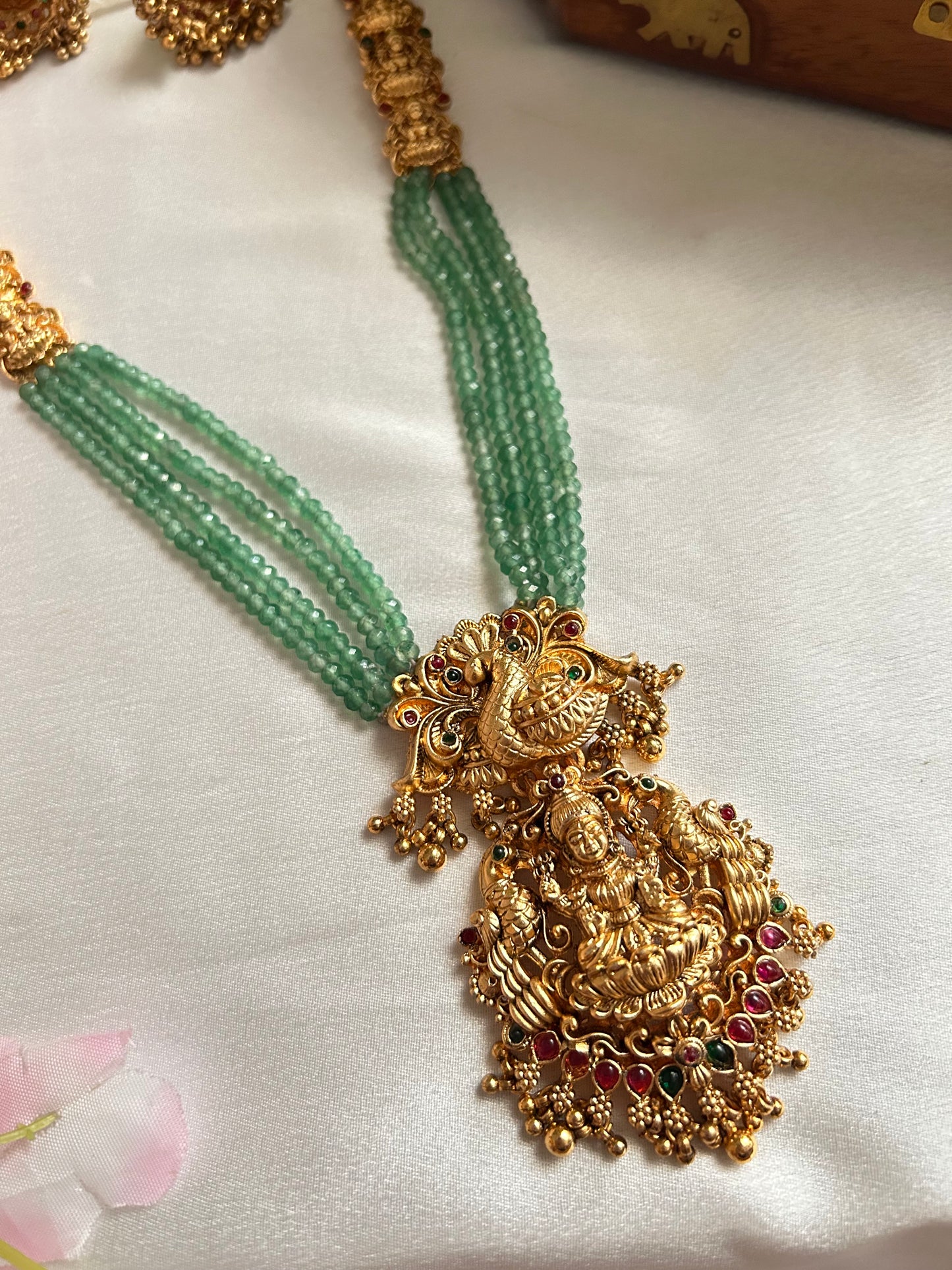 Gold plated green beaded Long Haaram with heavy Laksmi pendant.