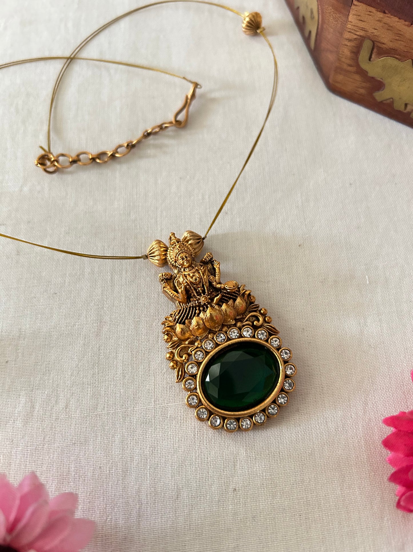 Gold Plated Invisible Necklace with Lakshmi Pendant - Embedded with Oval Shaped Emerald Green