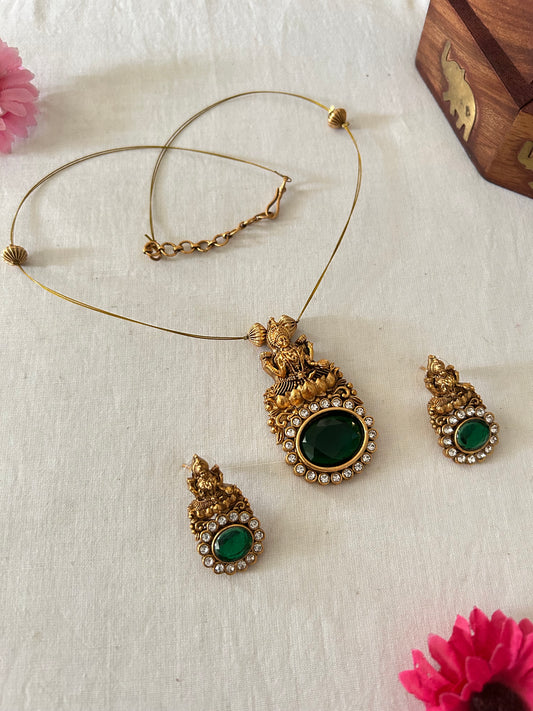 Gold Plated Invisible Necklace with Lakshmi Pendant - Embedded with Oval Shaped Emerald Green