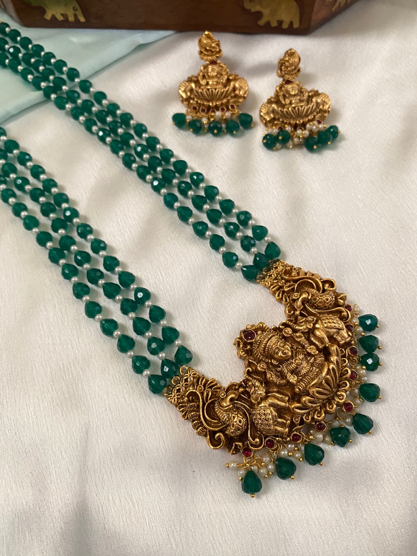 Gold Plated Long Haram with heavy laksmi pendant and medium green beads
