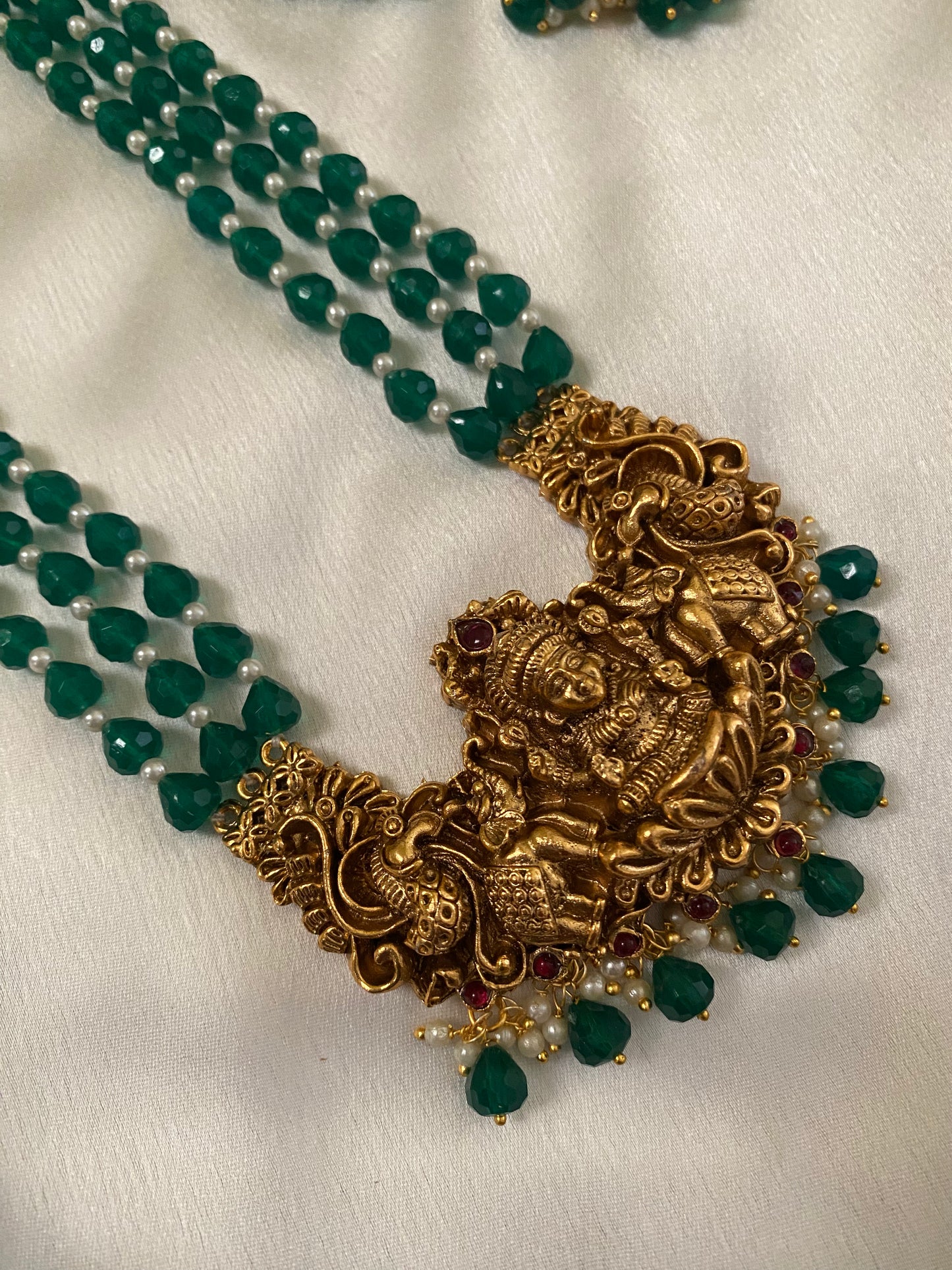 Gold Plated Long Haram with heavy laksmi pendant and medium green beads