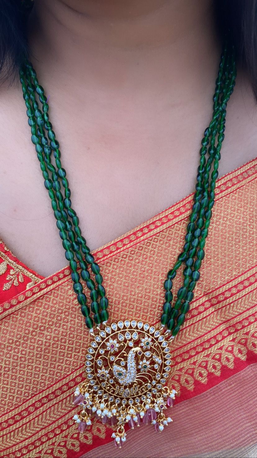 Luxehara's Long set jewellery with green monalisa beads and heavy pendant embedded with cz stones, pearls and monalisa beads.